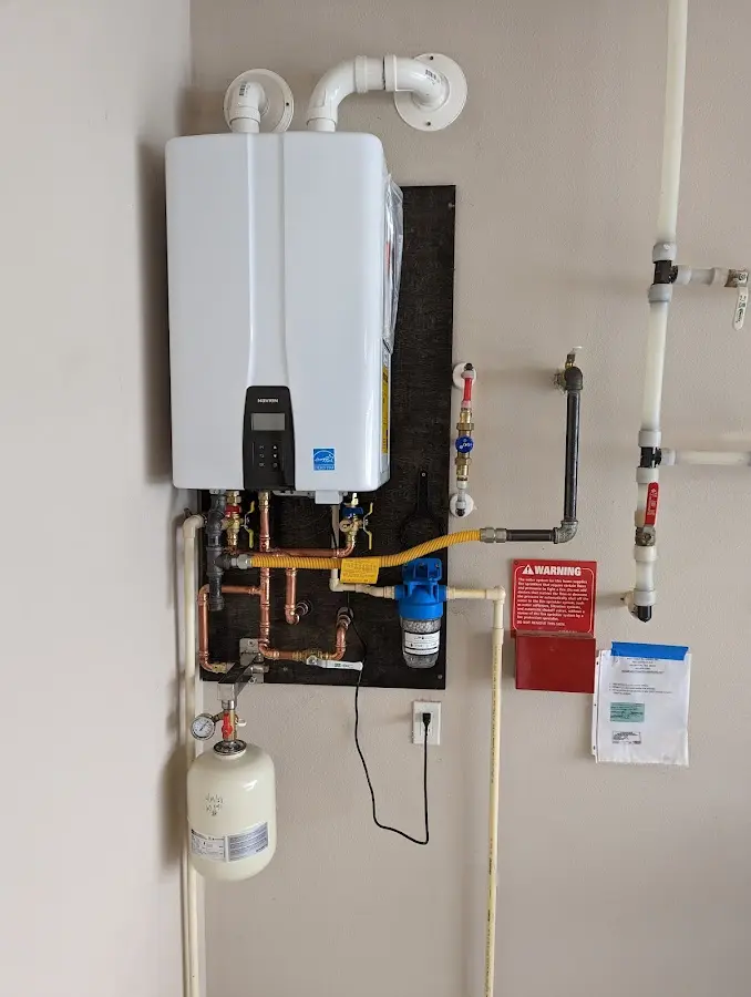 Professional plumber installing copper piping in a Brentwood home